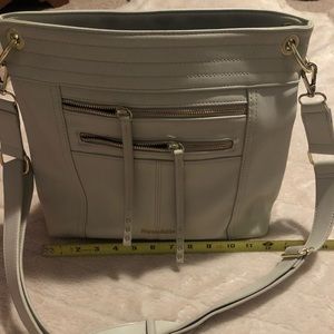 Light beige/cream purse with gold accents.